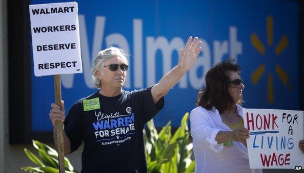 Walmart protestors holding sign