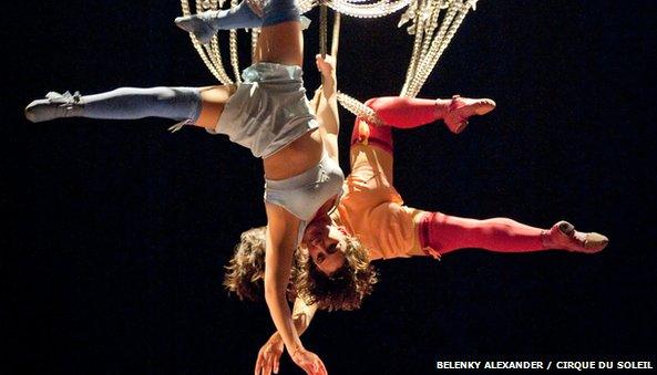 Cirque du soleil performers hanging from chandelier