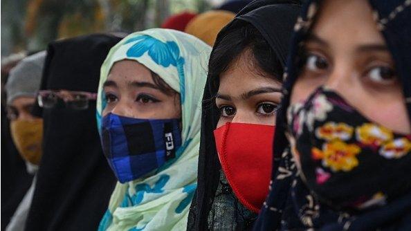 Students carrying placards take part in a demonstration in Kolkata on February 9, 2022