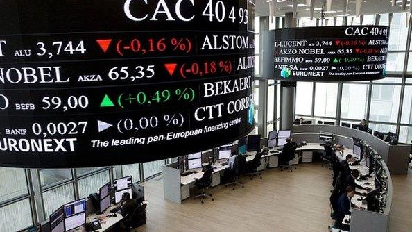 Traders work at the French stock exchange in La Defense, near Paris