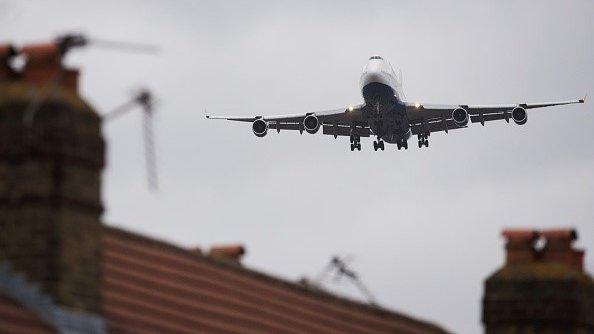 Plane flying above a house