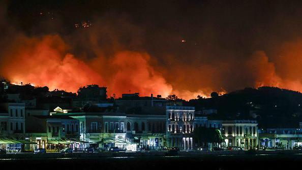 A wildfire rages in the hills above Chios Town in the Aegean. Wildfires are exacerbated by extreme heat, drought and fanning winds