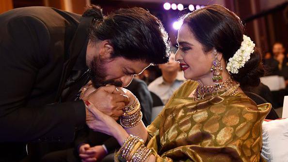 Bollywood superstar Shah Rukh Khan greets Rekha at an award ceremony