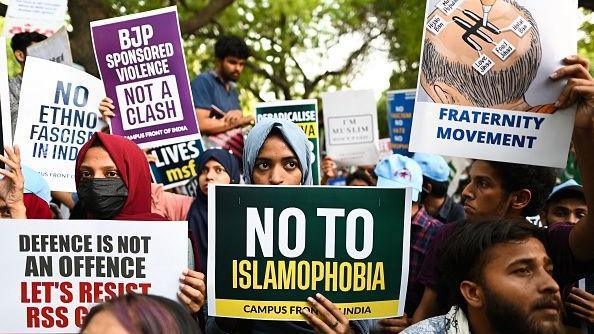 Protesters hold placards that read "no to Islamophobia" and "BJP sponsored violence not a clash" during a demonstration against anti-Muslim violence and hate crimes in New Delhi on April 16, 2022.