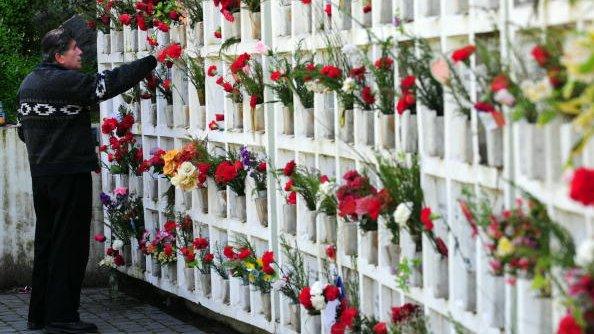 A man visits symbolic graves of prisoners who disappeared during the military dictatorship (1973-90) of General Augusto Pinochet in the national cementery of Santiago