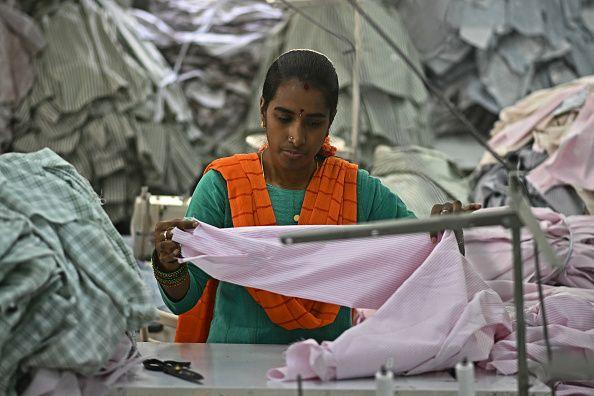A garment worker sorts tailored shirts at an apparel manufacturing unit in Bengaluru on August 25, 2025.