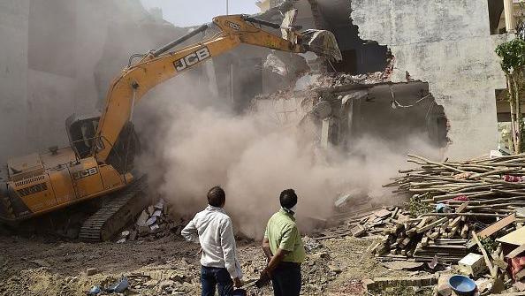 A bulldozer is being used to demolish the illegal structures of the residence of Javed Ahmed, a local leader who was allegedly involved in the recent violent protests against Bharatiya Janata Party (BJP) former spokeswoman Nupur Sharma's incendiary remarks about Prophet Mohammed, in Allahabad on June 12, 2022. 