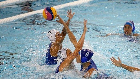 A Cuban player tries to score past Diana Carballo of Mexico during their women's water polo preliminary group match in the Toronto 2015 Pan Am Games at Atos Markham Centre on July 11, 2015 in Toronto, Canada.