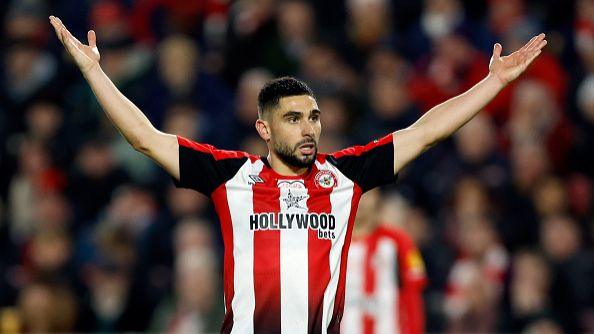 Neal Maupay holds his hands aloft.