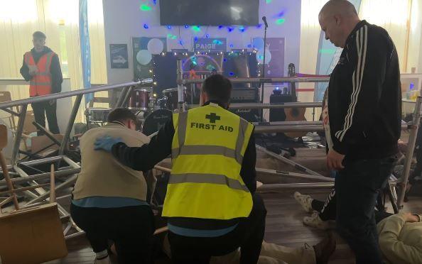 A first aid responder responds to casualties following a mocked up stage collapse during a training exercise 