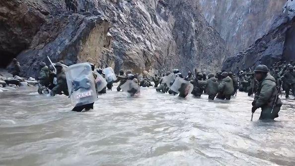 This video frame grab taken from footage recorded in mid-June 2020 and released by China Central Television (CCTV) on February 20, 2021 shows Indian soldiers crossing a river during an incident where Chinese and Indian troops clashed in the Line of Actual Control (LAC) in the Galwan Valley, in the Karakoram Mountains in the Himalayas