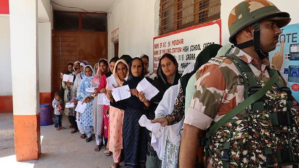 People are standing in queues and showing their voting cards at a polling station during the sixth phase of Lok Sabha elections near the Line of Control (LoC) in Poonch, India, on May 25, 2024. (Photo by Nazim Ali Khan/NurPhoto via Getty Images)