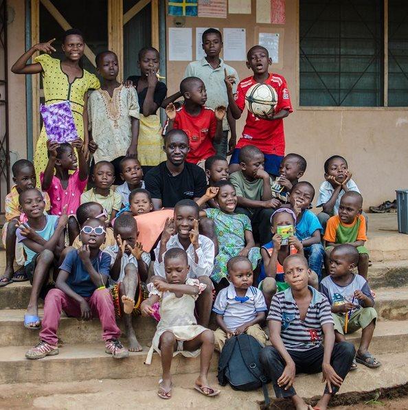 The children and Solomon Adufah posing outside the school