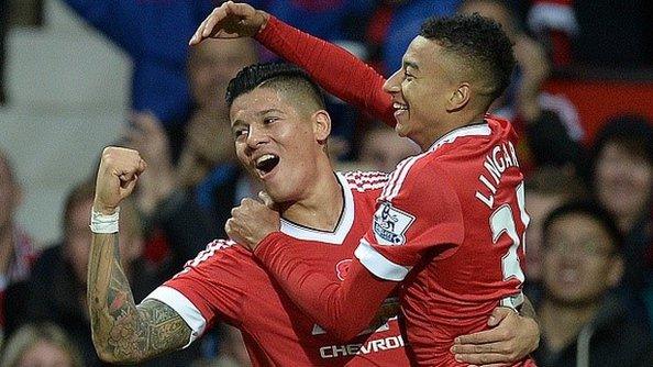 Manchester United's Jesse Lingard (R) celebrates scoring his team's first goal with team mate Marcos Rojo