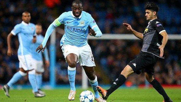 Yaya Toure of Manchester City makes a break past Mahmoud Dahoud of Borussia Moenchengladbach