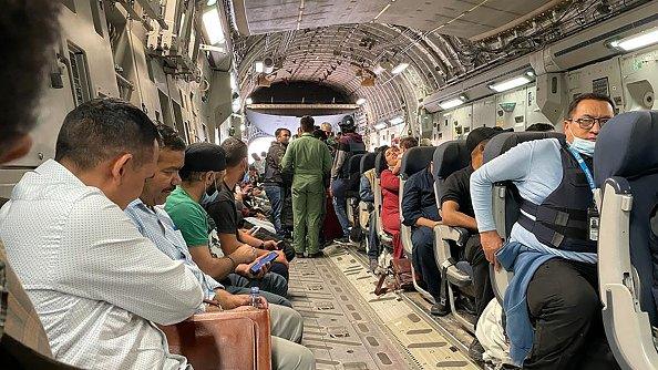 Indian nationals sit aboard an Indian military aircraft at the airport in Kabul on August 17, 2021 to be evacuated after the Taliban stunning takeover of Afghanistan