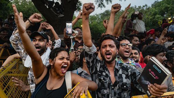 Supporters of India's Cockroach Janta Party (CJP) celebrate following the resignation of Education Minister Dharmendra Pradhan, after days of protests demanding he step down over the alleged NEET examination paper leak scandal on July 25, 2026 in New Delhi, India.