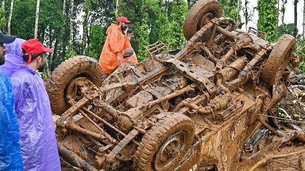 Rescue workers check a damaged vehicle after the landslides in Wayanad on August 1, 2024. 