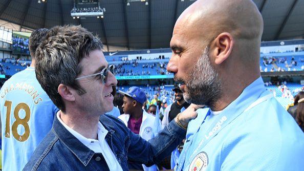 Noel Gallagher and Pep Guardiola on the pitch, celebrating the winning the Premier League in 2018.