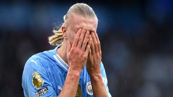 Erling Haaland covers his face in dismay.