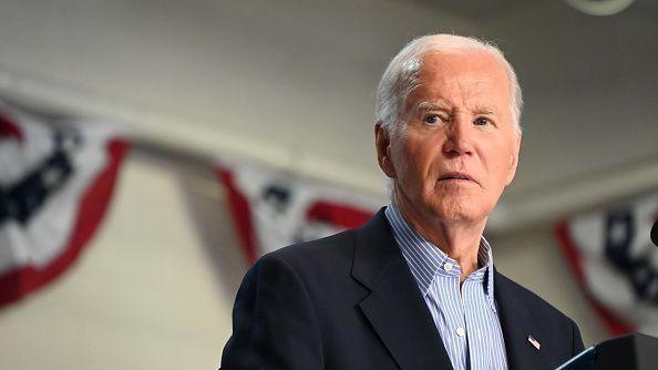 Joe Biden looking off to the side, standing at a podium