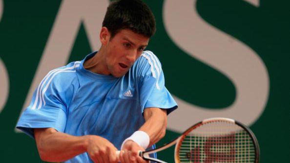 Novak Djokovic hits a backhand against Roger Federer, 2006.