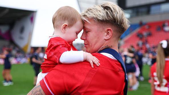 Rose with her young daughter Margot after playing for Wales