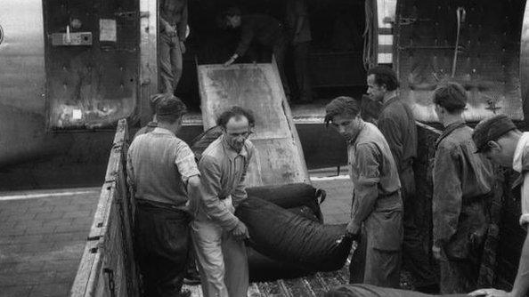 The first load of coal to be delivered by air as part of the Berlin airlift arrives at Tempelhof Airport