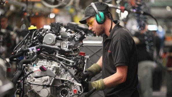 Technician works on a car engine at a Nissan factory in Sunderland