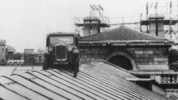 Austin Seven van on top of Cambridge University's Senate House