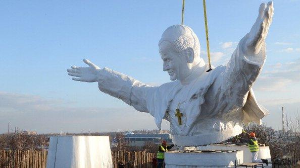 Workers put together elements of a 13,8m tall sculpture of late Pope John Paul II in Czestochowa, southern Poland, 7 April 2013