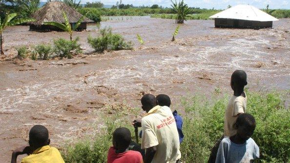 Residents of Kano plains look on 14 April 2013 at one of the homes that was submerged by flood waters after the Nyando river burst its banks, displacing families in the area and forcing most to move to higher grounds for safety