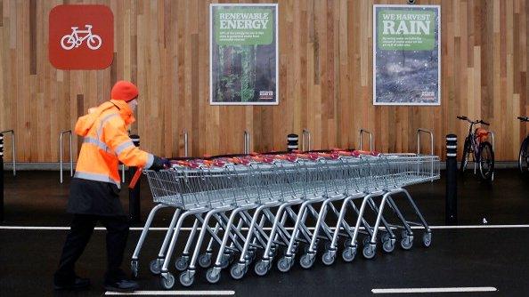 Sainsbury's employee pushes trolleys in King's Lynn