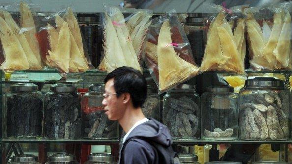 A man walks by a store selling shark fins in Hong Kong