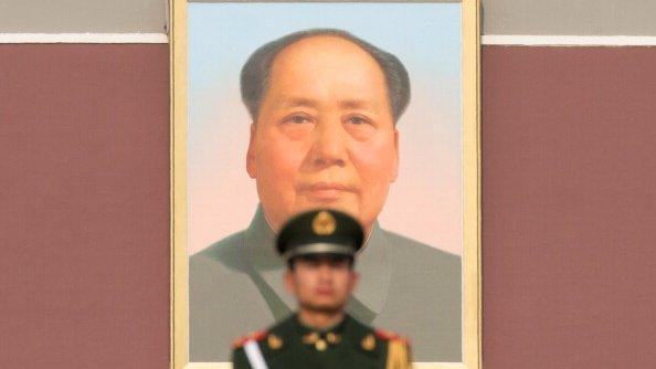 File photo: Paramilitary guard in front of a portrait of Mao Zedong in Tiananmen Square, 15 November 2012