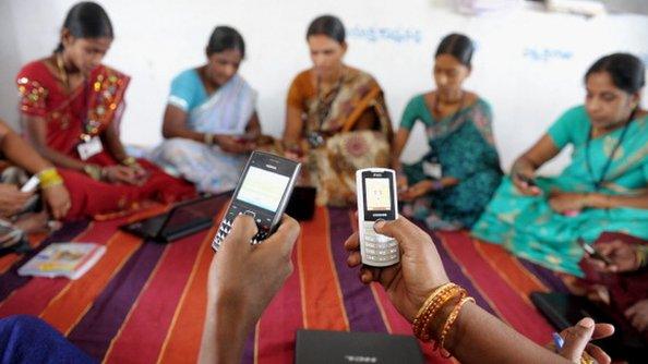 Women using mobile phones in India