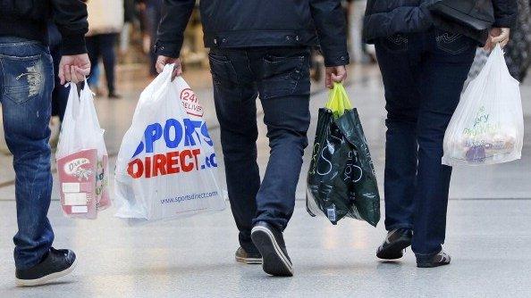 Shoppers carrying Sports Direct bags