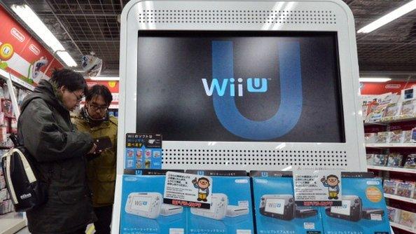 Consumers standing next to Nintendo wii console