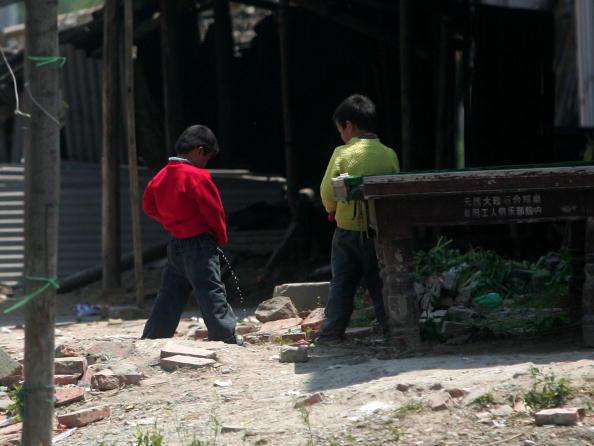 Two Chinese Children peeing on the street