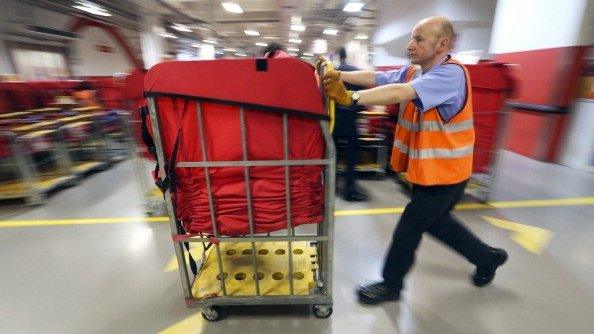 Man pushing sorted parcels