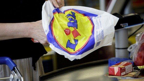 A man holding a Lidl shopping bag