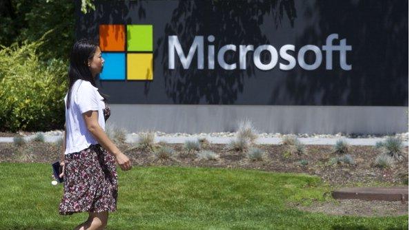 Microsoft logo with woman walking by