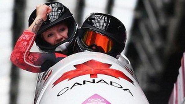 Kaillie Humphries (front) and Heather Moyse of Canada team 1 celebrate winning the gold medal during the Women's Bobsleigh