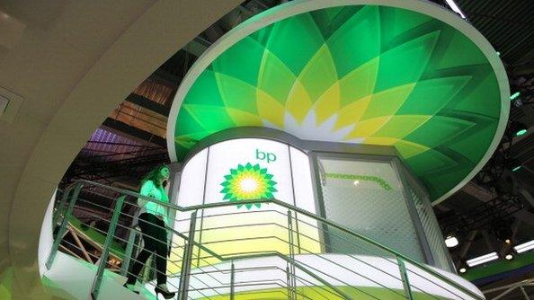 A Woman walks past a BP sign