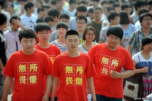 Students wear T-shirts saying 'fear nothing' as they walk into a room to write the 2014 'gaokao' college entrance exam in China in June 2014.