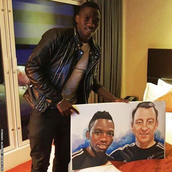 Kenneth Omeruo poses with a portrait of himself and John Terry