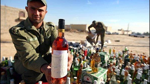 Soldiers inspecting seized alcohol