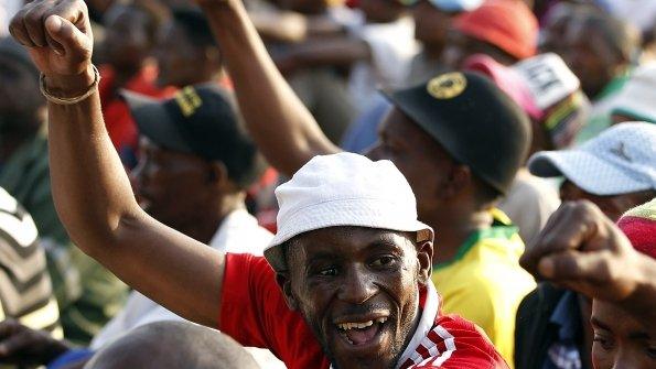 Striking miners gesture after they were informed of a 22 percent wage increase offer outside Lonmin"s Marikana mine, 100 km (60 miles) northwest of Johannesburg, September 18, 2012