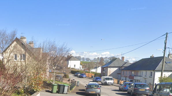 Laurel Bank Terrace in Castle Douglas. There are cars parked on either side of a residential street.