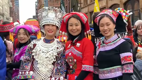 Four women dressed in ornate traditional dresses at the Manchester parade